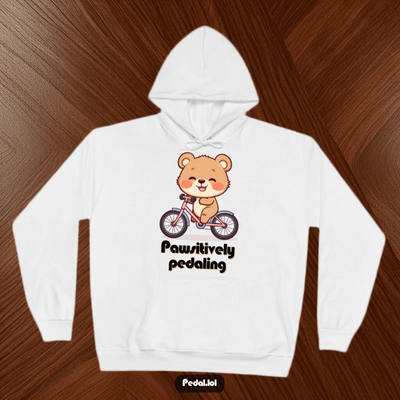 Funny Hoodie: A happy bear cub cruises on a tiny bike with a huge grin, radiating warmth and playful adventure.