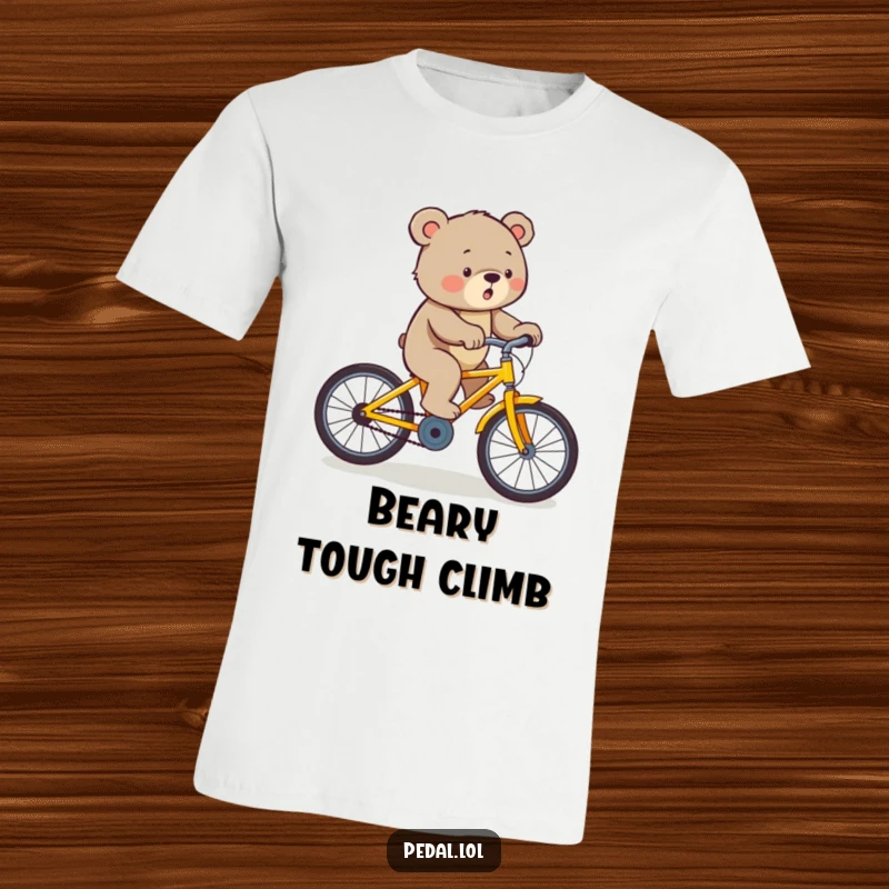 Funny bear exerting effort to pedal a yellow bicycle uphill, a humorous t-shirt for the determined.